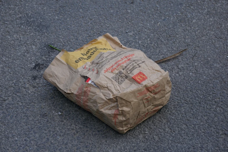 the paper bag is on the ground with several writing on it