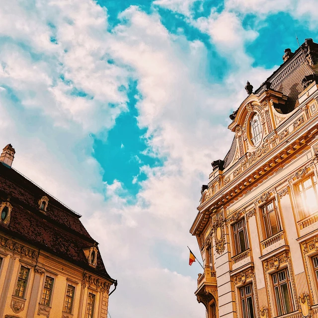 the old buildings are against the blue and white sky