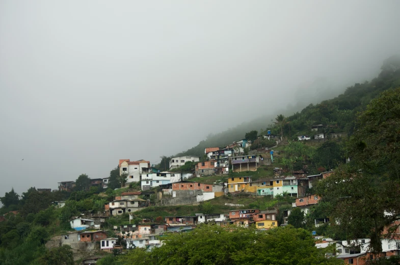 a mountain is covered with colorful houses on top