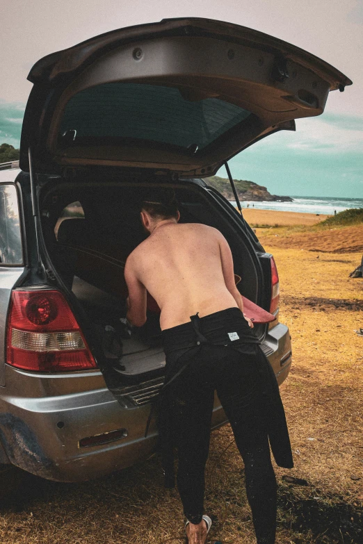 a man in his car looking inside