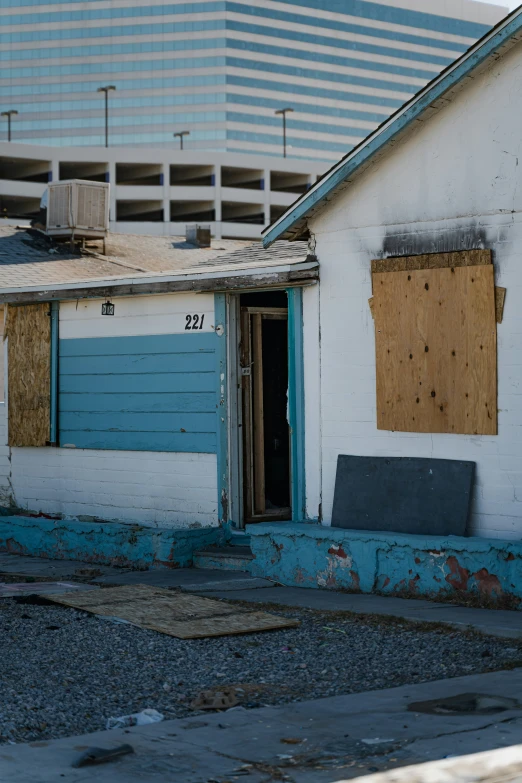 an abandoned building with a broken window and sign