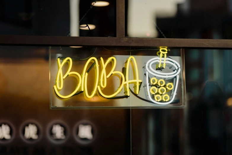 a yellow neon sign is attached to the side of a window