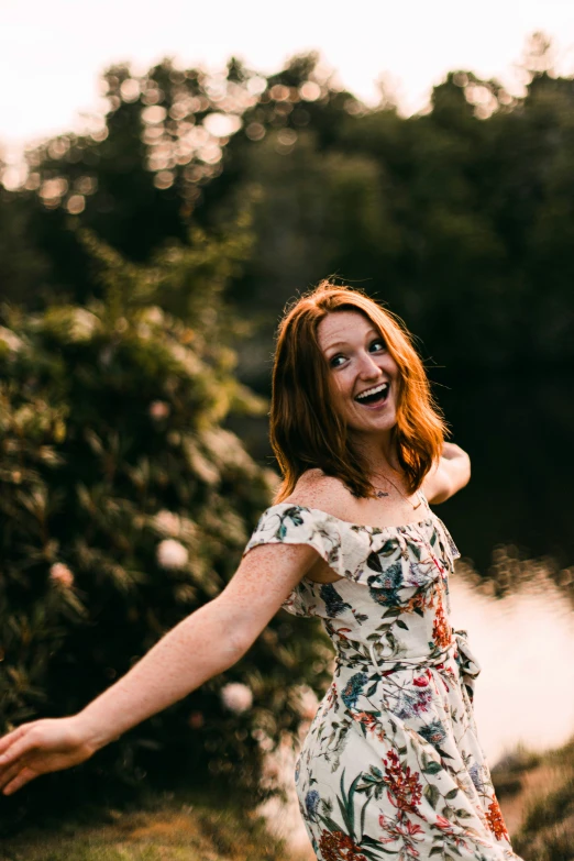 an image of a woman in floral dress with arms spread