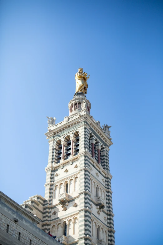 looking up at the top of a large white building with a clock