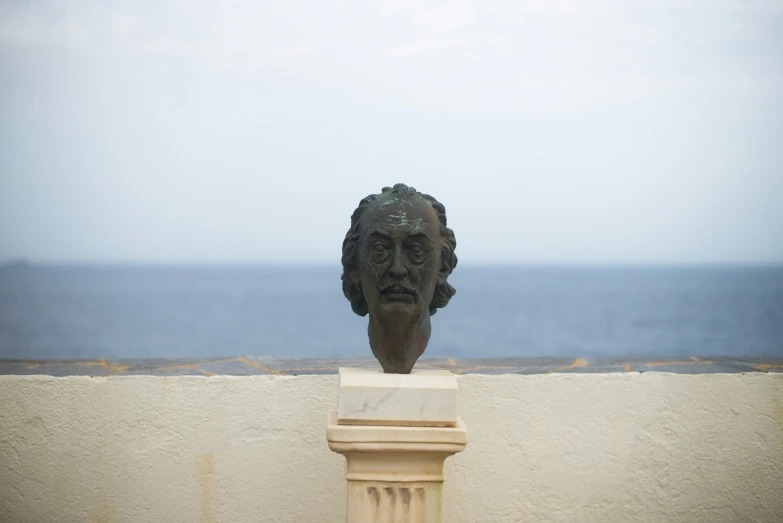 a bust of an individual next to a building