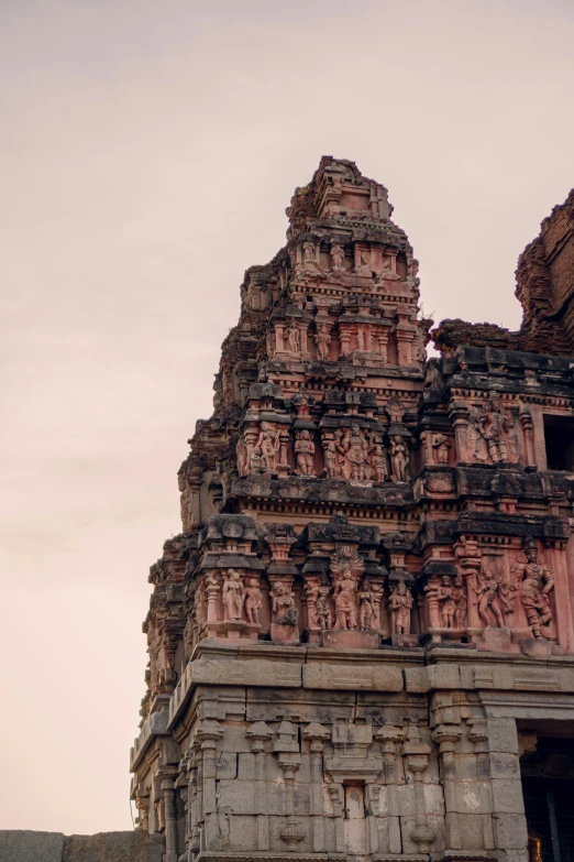 a very tall old building with carvings on it