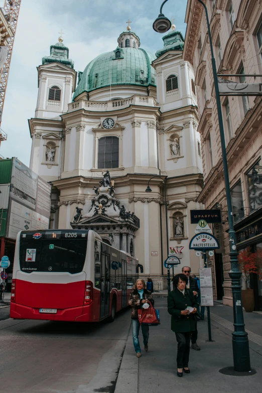 two large buses stopped by a cross walk