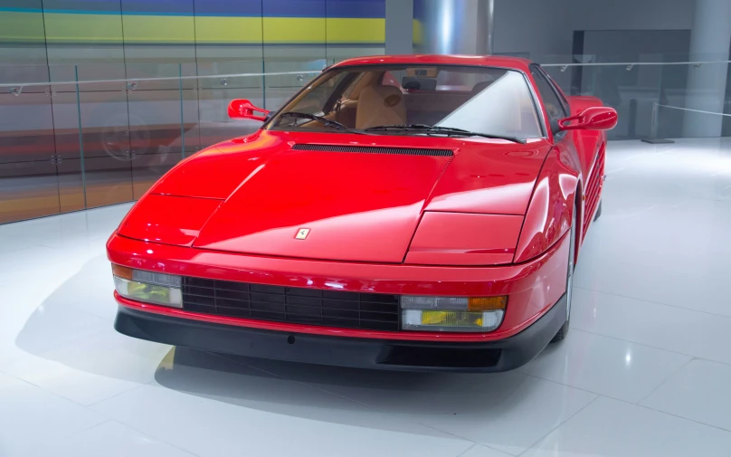 a red sports car is parked inside a building