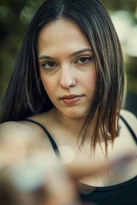 a woman with long brown hair looking off to the side