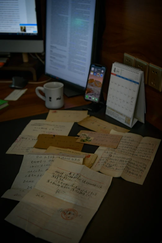 some pieces of paper and a calendar on a desk