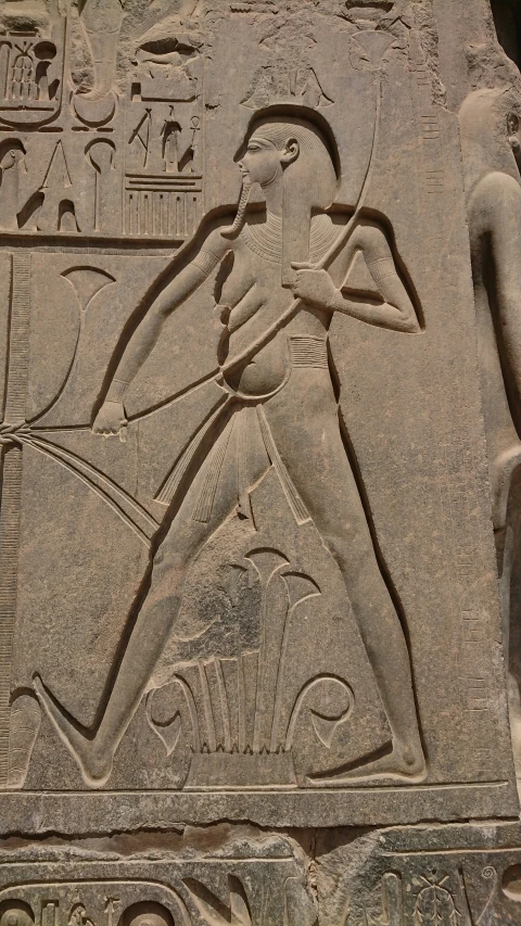 ancient statue of an egyptian god next to the sun