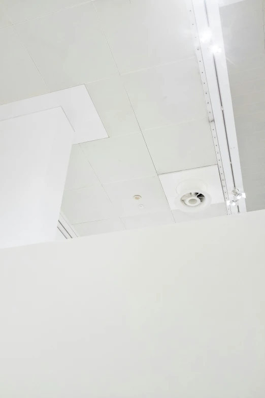 a white ceiling with some lighting next to it