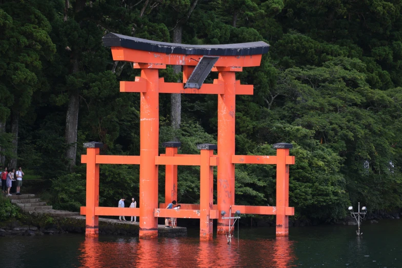 an orange floating sculpture that looks like it has people in the water