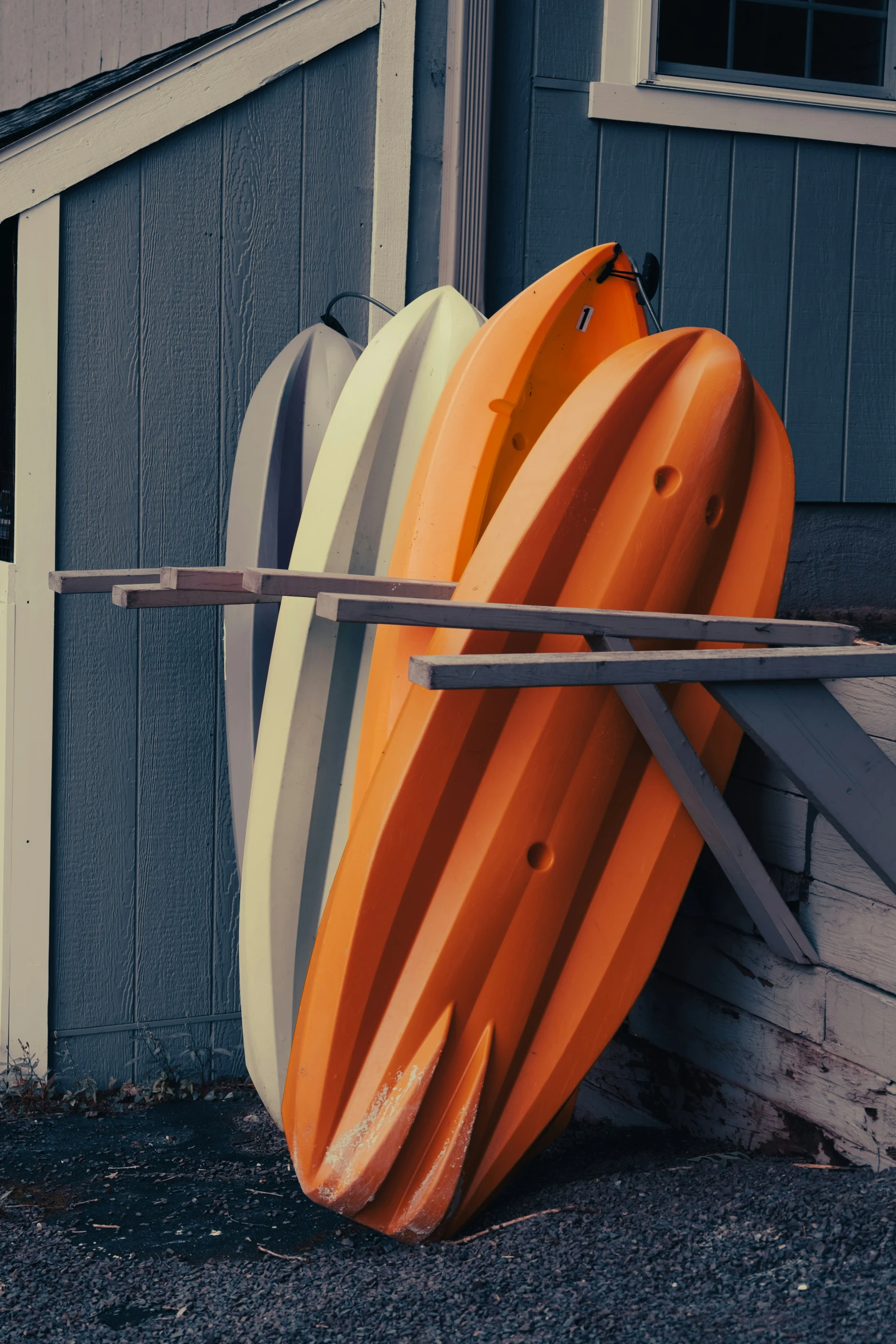 some surfboards leaning on the side of a building