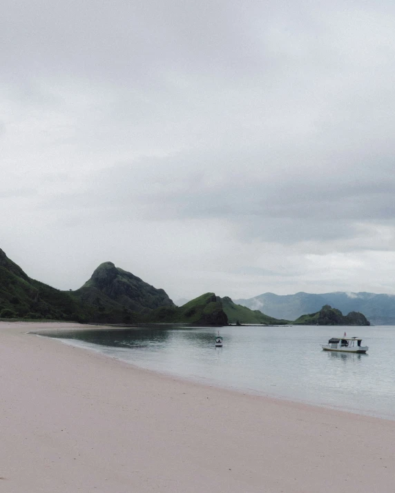 two boats on a white sandy beach