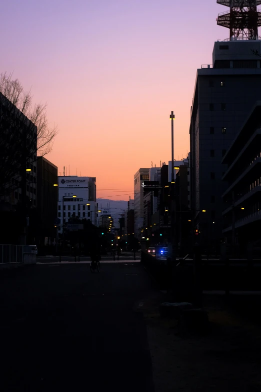 city with tall buildings and street lights at night