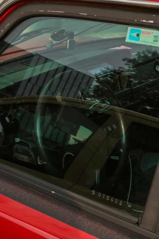 the back window and trunk of a red car