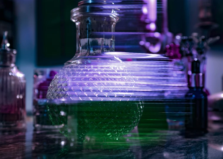 some glass jars sitting on a table and purple glass