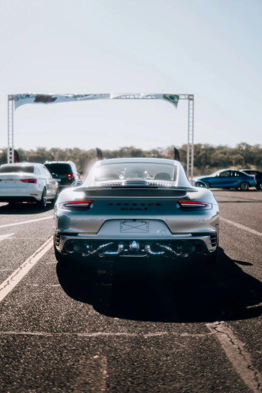 a white porsche parked in a parking lot