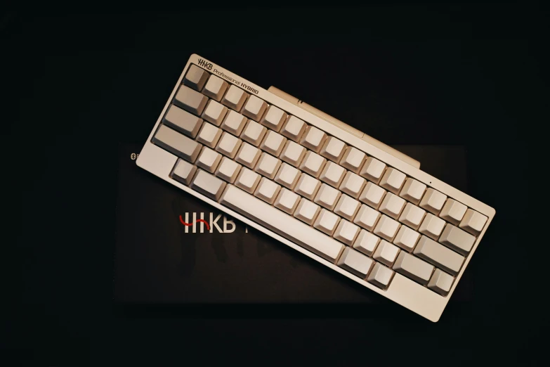 a brown and white computer keyboard on top of a mouse pad