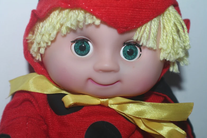a red doll with big eyes wearing a red hat