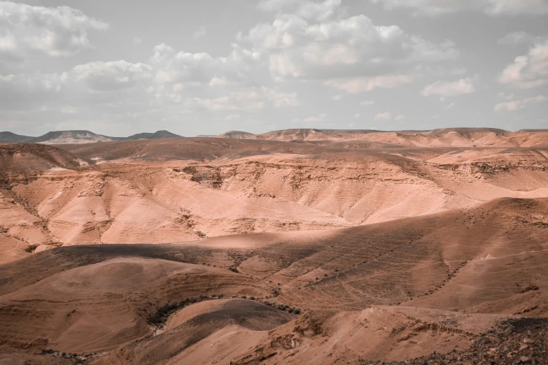 the vast mountainous plain has large, barren terrain in the background