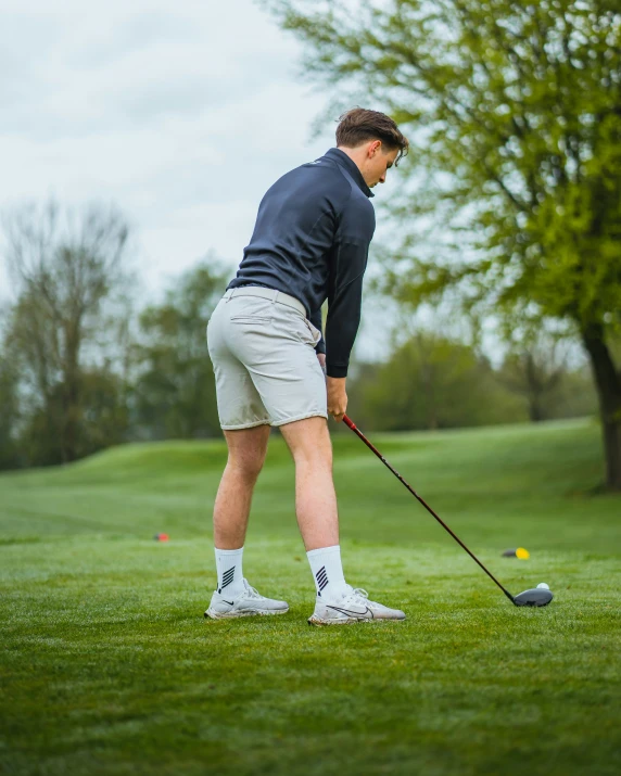 a man is playing golf and getting ready to hit the ball