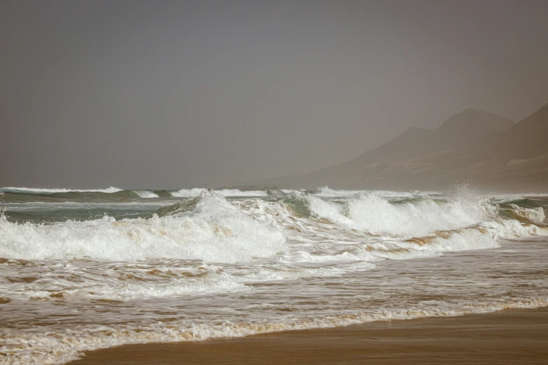 a lone surf board in the waves of the beach