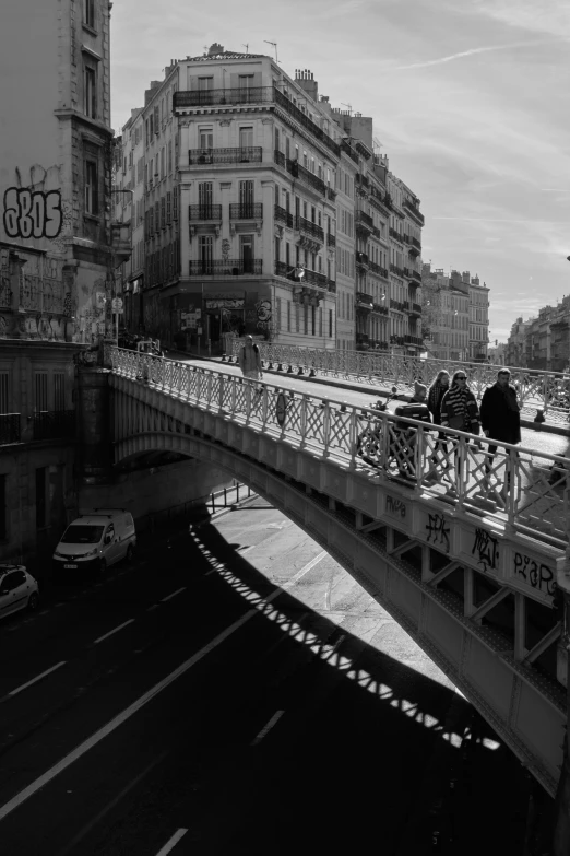 the street on the bridge has cars driving underneath it