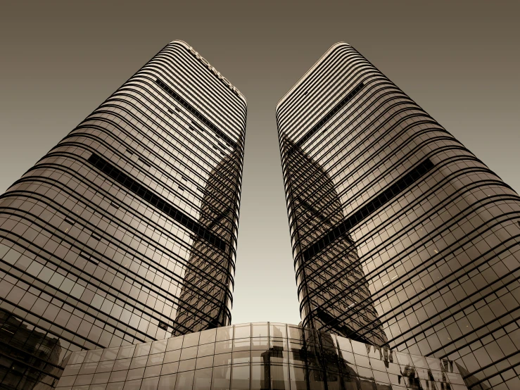 two modern buildings rise up into the blue sky