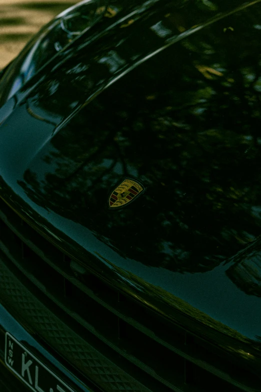 the hood of a car that has a sticker with a yellow emblem