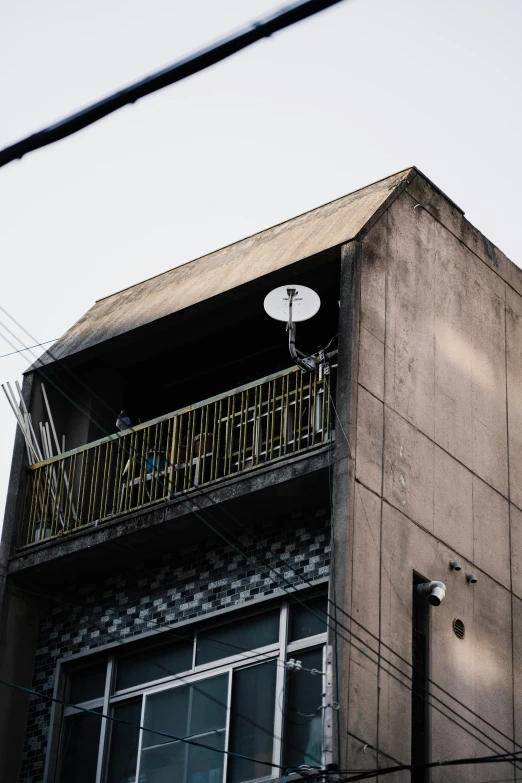 a tall building with an awning and a clock on the outside