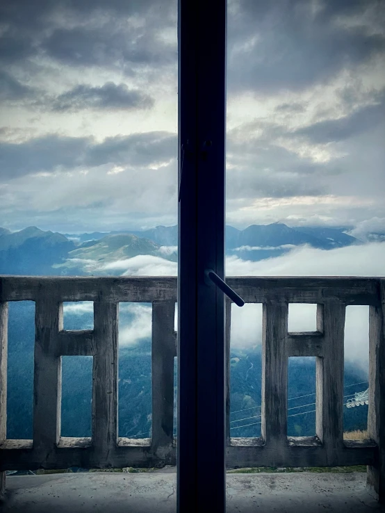 two windows overlooking the valley below with mountains