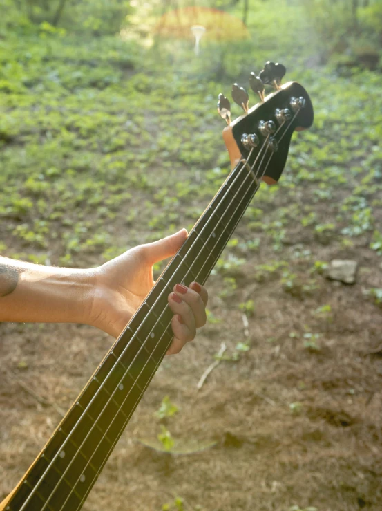 a man holding a bass guitar in his hands