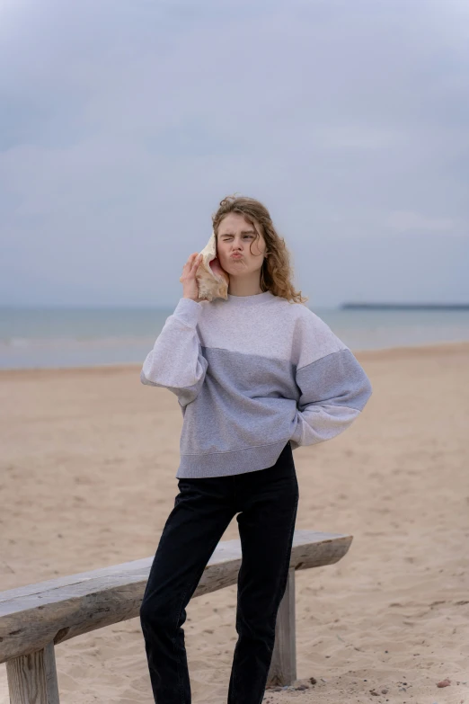 the woman poses for a picture on the beach