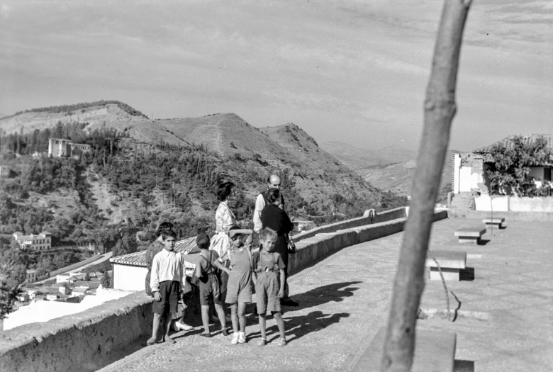 a group of people standing on top of a stone walkway