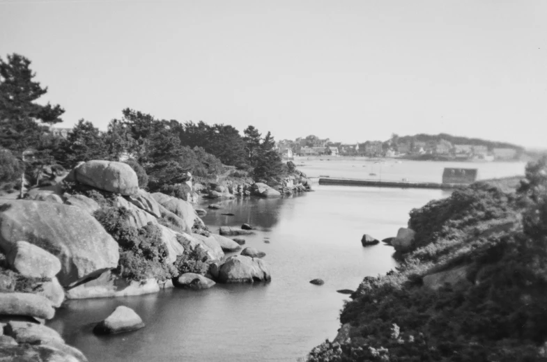 a lake with rocks and trees in the water