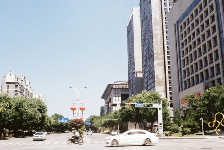 a man on a motorcycle is driving down the street