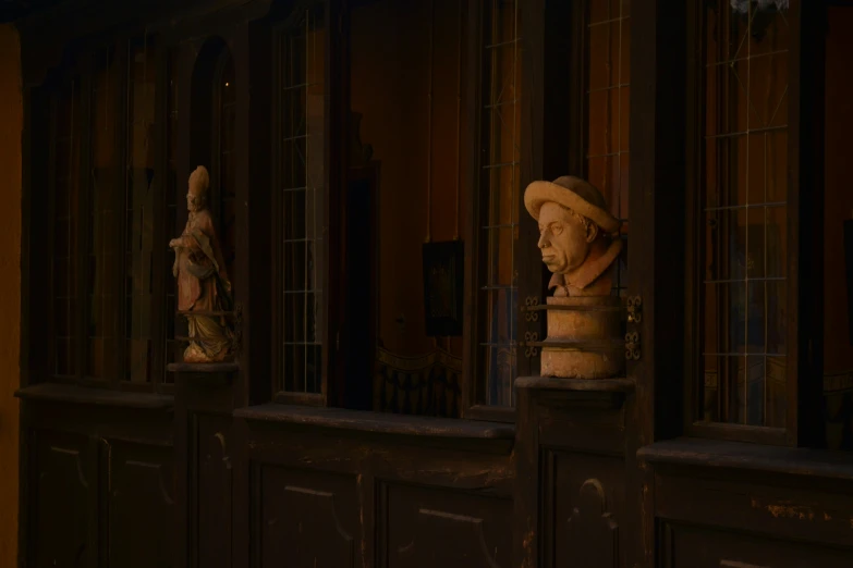 a set of carved heads on a wooden door