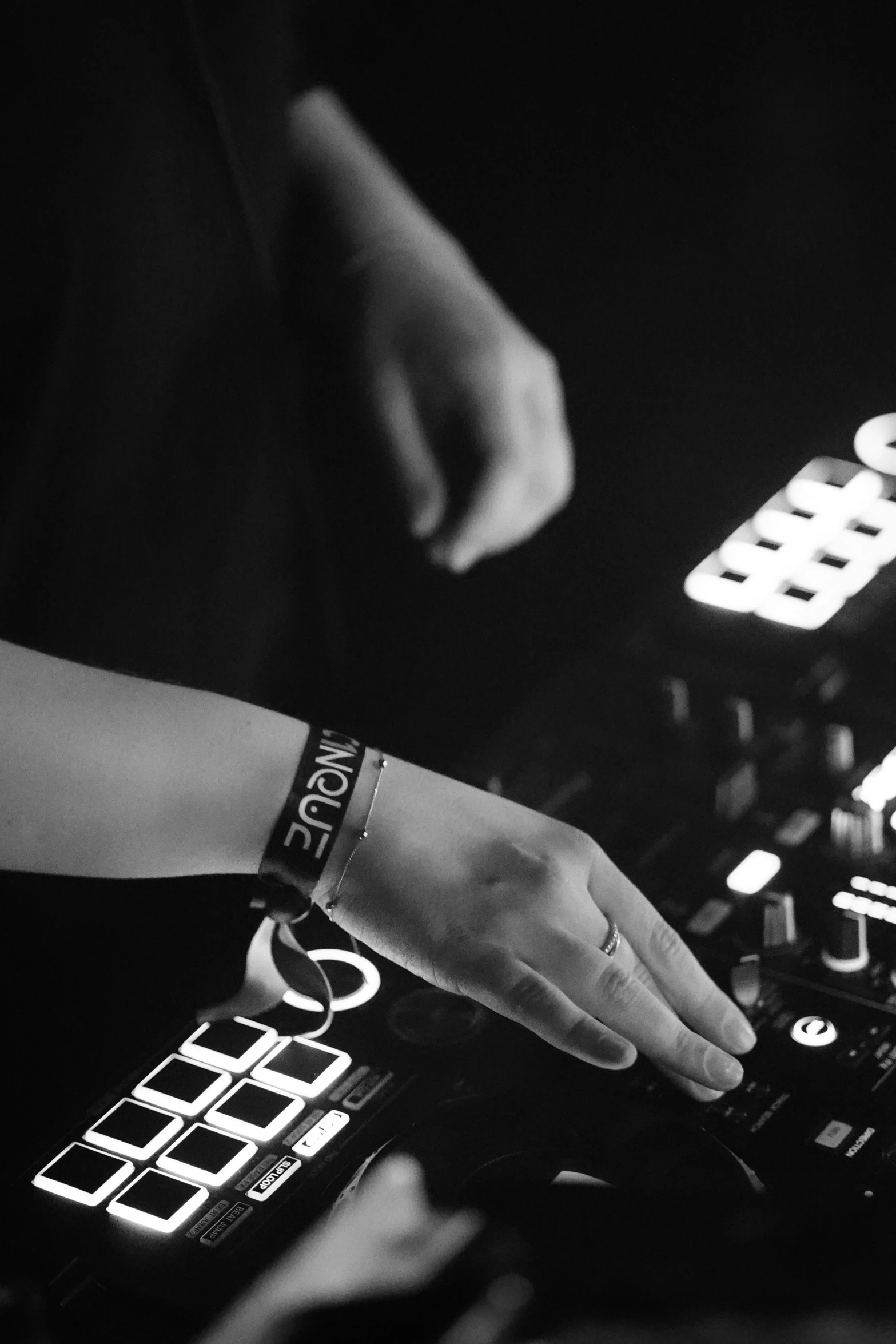 hands using the controls of a mixing console