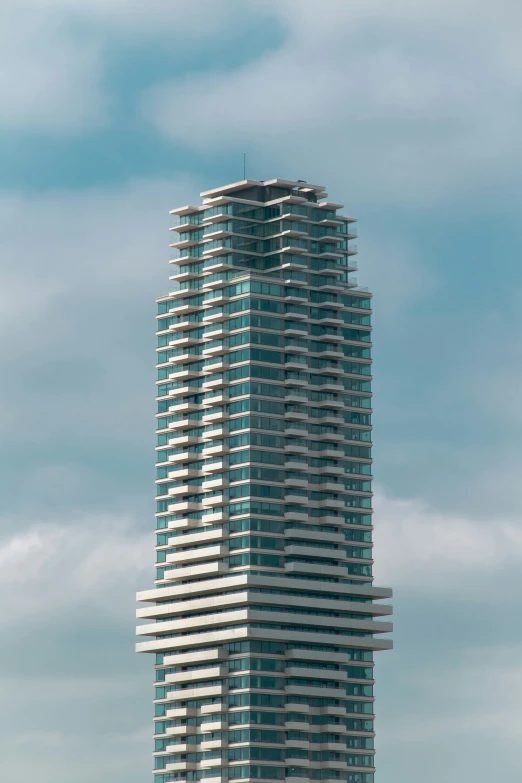 a very tall, glass and steel building on a beach