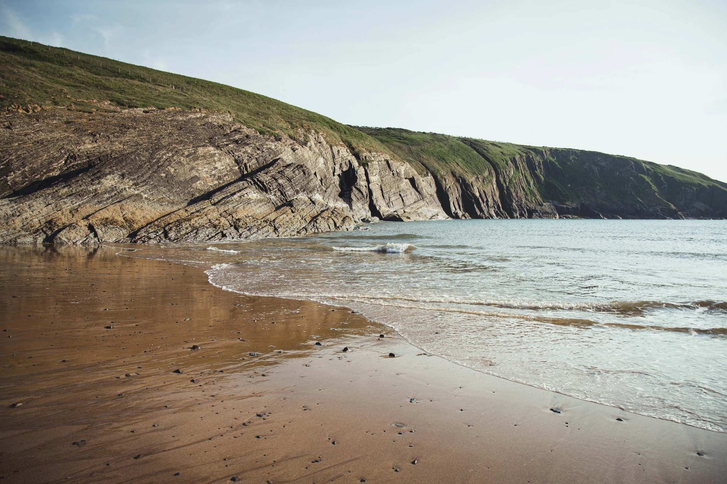 this is an image of a beach and a steep hill