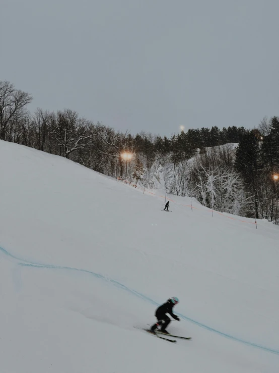 skiers making their way down a snow covered slope