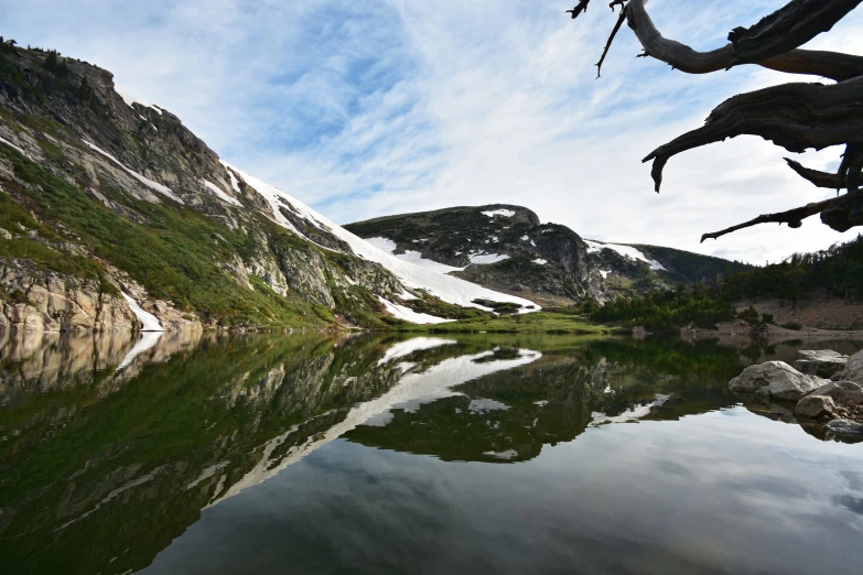 a lake with some snow on the tops