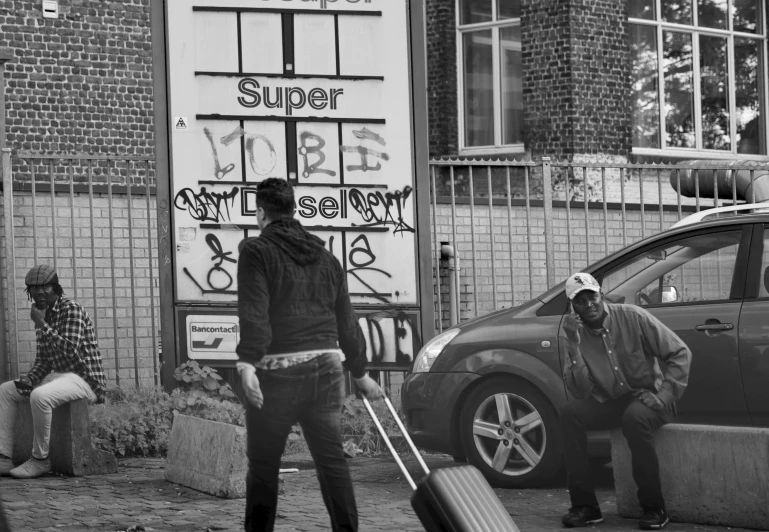 two men are hing their suitcases outside