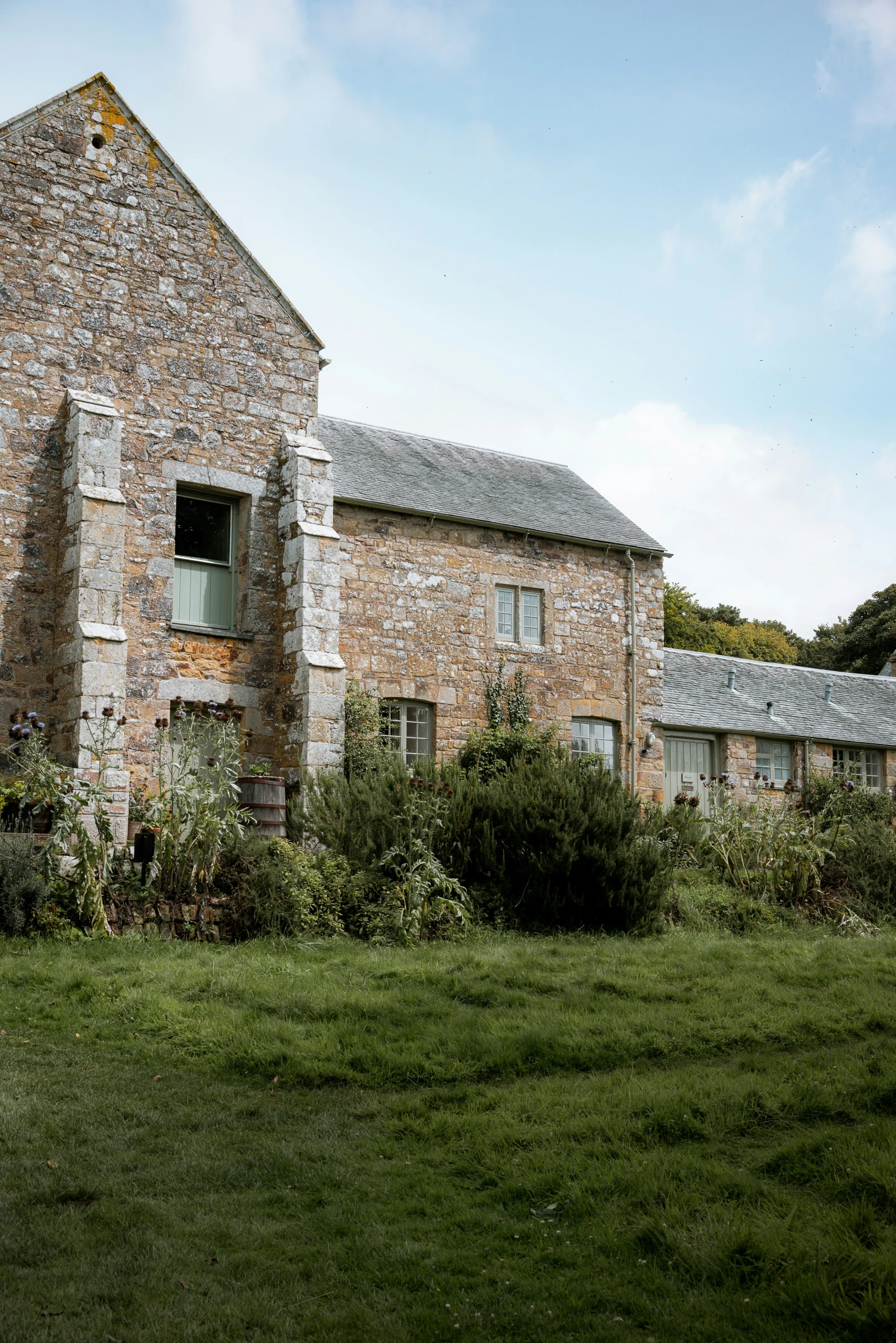 an old house in a lush green field