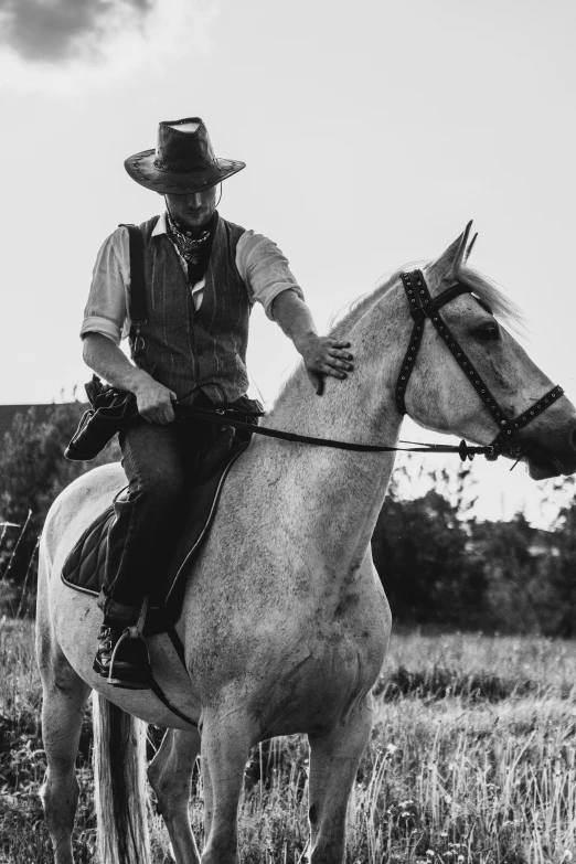 black and white pograph of a person on a horse