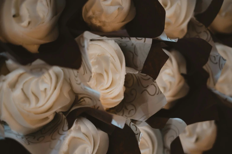 some white paper flowers are stacked high together