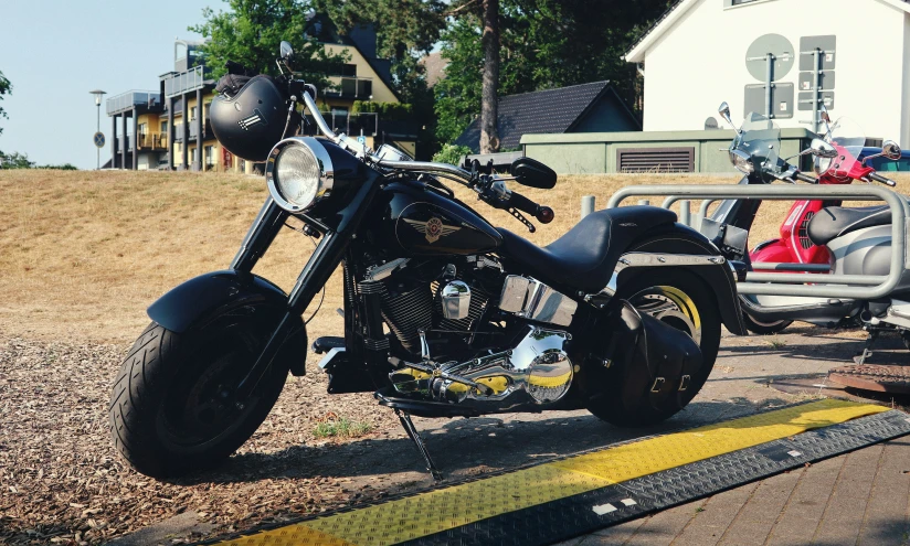 a close - up of an old fashion harley davidson motorcycle parked on a roadside