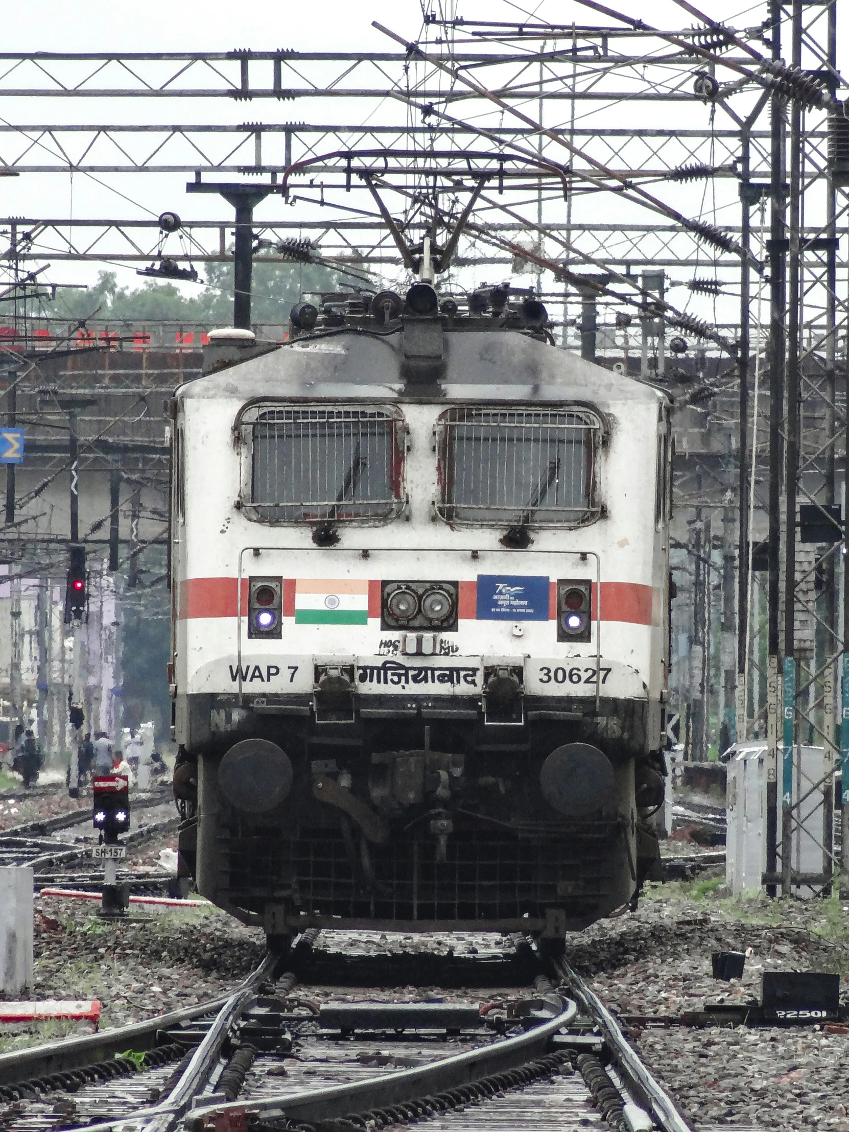 a train traveling down the tracks in an industrial area